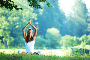 Beginnings Treatment Centers woman practicing yoga in park