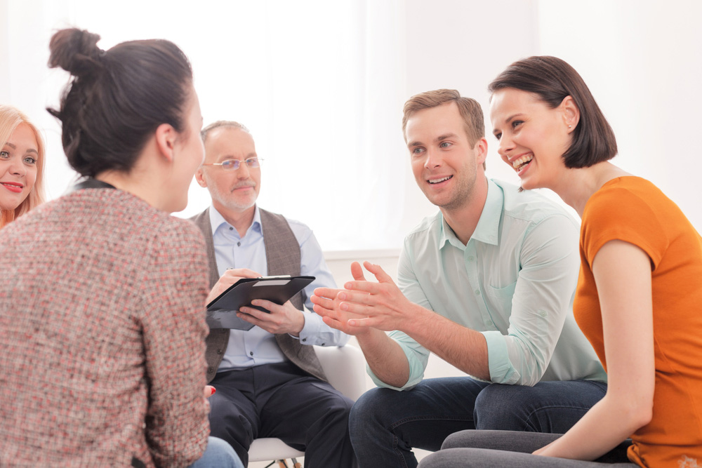 beginnings-treatment-centers-how-to-live-with-an-addict-post-man-happy-people-in-addiction-therapy-group beginningstreatment-night-iop-addiction-treatment-photo-young-man-with-phone-474848428