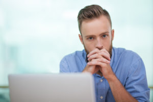 beginnings-treatment-centers-adderall-addiction-and-abuse-article-image-of-stressed-out-man-at-desk-in-front-of-computer