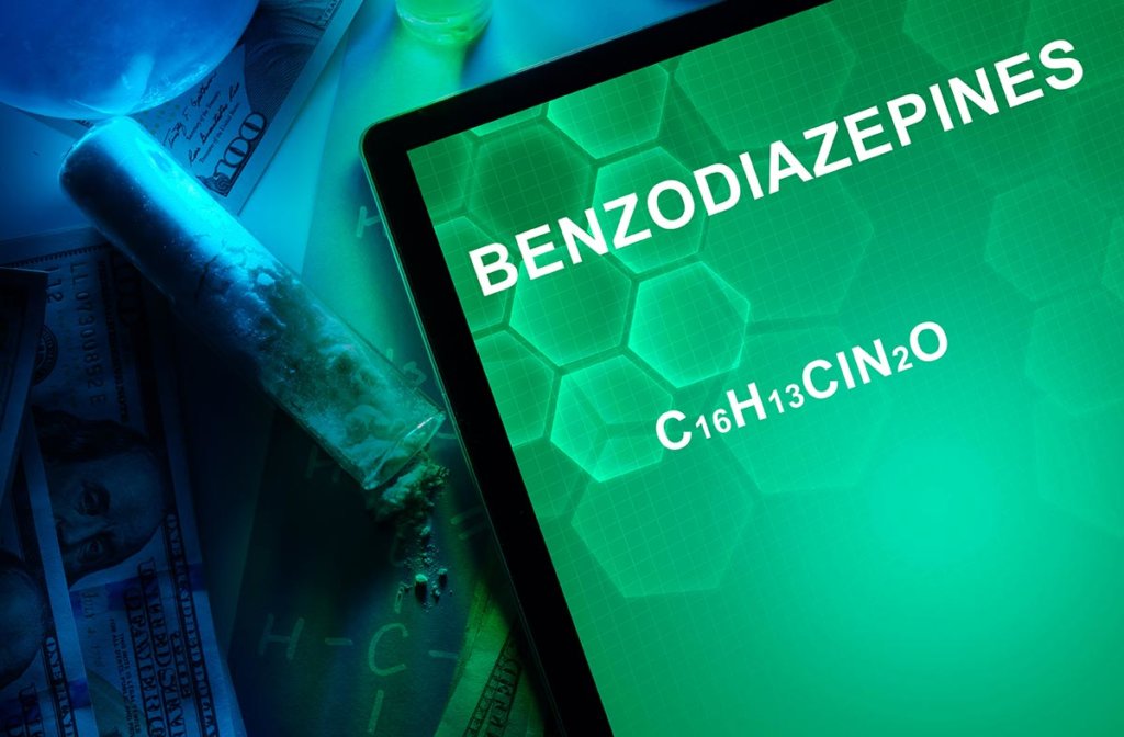 beginningstreatment-benzodiazepine-addiction-the-prescription-drug-that-can-ruin-lives-article-photo-tablet-with-the-chemical-formula-of-benzodiazepines-drugs-and-narcotics-250781602