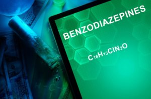 beginningstreatment-benzodiazepine-addiction-the-prescription-drug-that-can-ruin-lives-article-photo-tablet-with-the-chemical-formula-of-benzodiazepines-drugs-and-narcotics-250781602