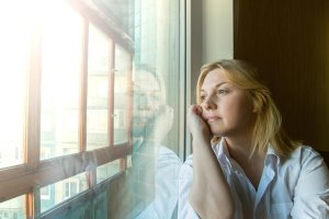 beginningstreatment-emotional-sobriety-do-i-have-it-article-photo-the-woman-lost-in-thought-looking-out-the-window-sunny-morning-288568835