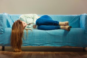 beginningstreatment-heroin-addiction-signs-symptoms-withdrawal-treatment-article-photo-loneliness-negative-emotion-concept-young-sad-stressed-woman-lying-on-couch-at-home-715170220