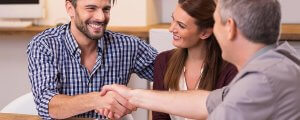 beginningstreatment-paying-for-rehab-photo-handshake-of-a-mature-manager-with-a-happy-young-couple-at-office-businessmen-handshake-during-416295319
