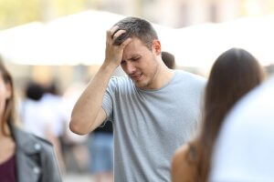 beginningstreatment-what-is-oxycontin-article-photo-of-a-man-suffering-head-ache-walking-on-the-street-695447155
