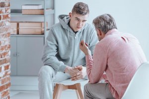 beginningstreatment-what-to-say-to-an-addict-in-denial-article-photo-rebellious-teenager-talking-with-counselor-about-his-issues-675117118