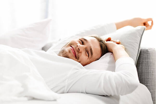 beginningstreatment-luxury-rehab-addiction-photo-picture-showing-young-man-stretching-in-bed-566717836 beginningstreatment-luxury-rehab-addiction-photo-picture-showing-young-man-stretching-in-bed-566717836
