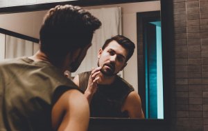 beginningstreatment-narcissistic-personality-disorder-and-addiction-article-photo-reflection-of-young-man-in-bathroom-mirror-looking-on-his-face-670025089