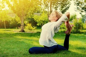 beginningstreatment-holistic-alternatives-to-opioids-for-pain-photo-beautiful-young-woman-doing-yoga-stretching-exercise-in-the-summer-park-healthy-lifestyle-yoga-222399724