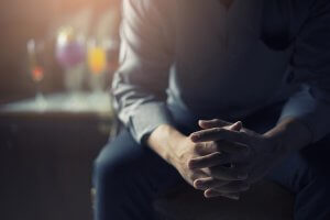 beginningstreatment-why-arent-there-more-non-abstinence-programs-article-photo-business-man-stress-and-hold-hand-and-with-alcohol-background-and-cross-process-and-soft-flare-648569542