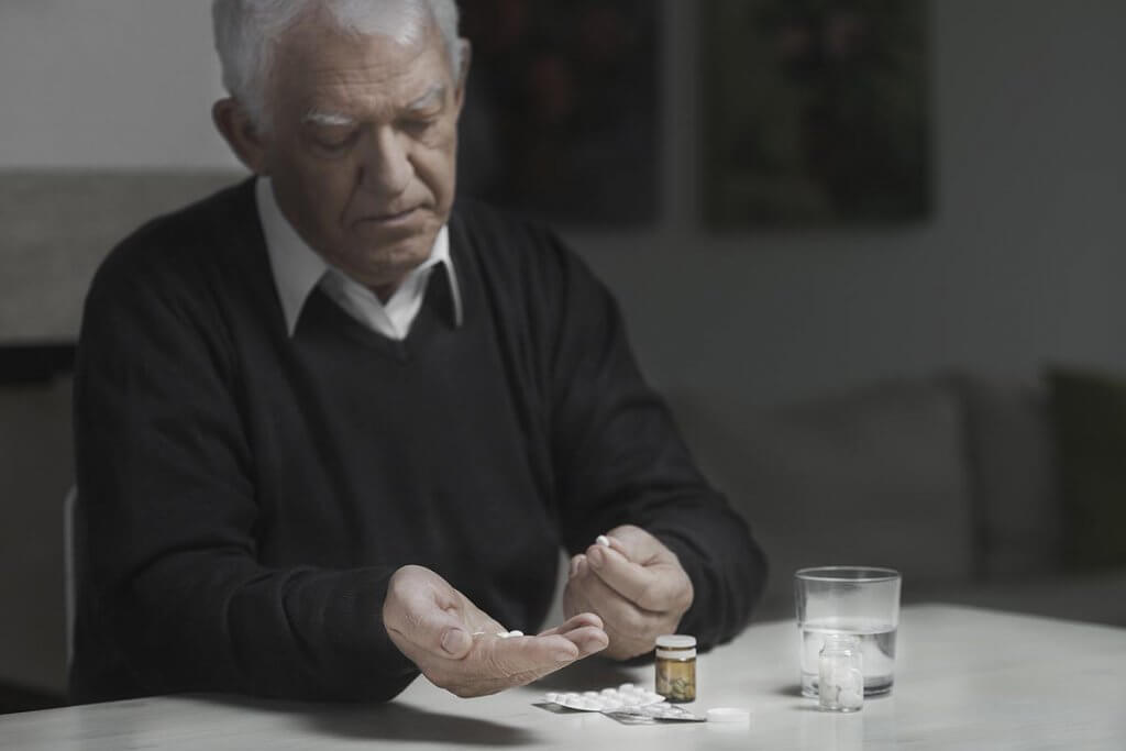 beginningstreatment-opioid-addiction-and-the-elderly-article-photo-senior-sad-man-taking-a-lot-of-medicines