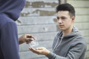 beginningstreatment-the-most-difficult-drugs-to-kick-article-photo-teenage-boy-buying-drugs-on-the-street-from-dealer