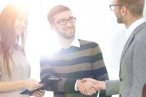 beginningstreatment-what-is-a-sober-companion-article-photo-friendly-handshake-between-colleagues