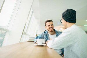 beginningstreatment-what-is-a-sober-companion-article-photo-men-are-sitting-in-front-of-the-table-and-near-window