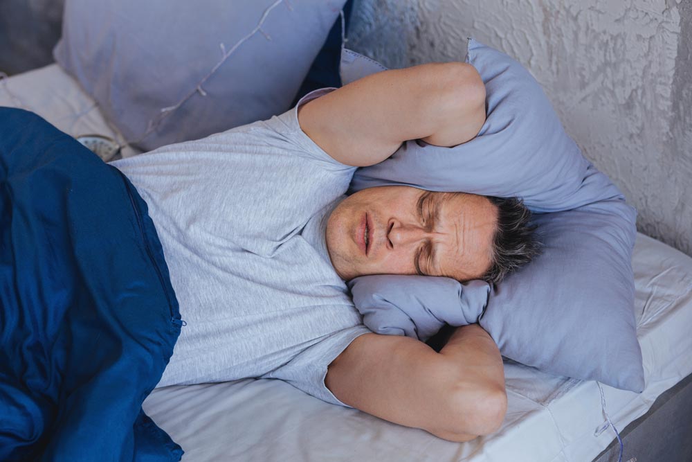 beginningstreatment-Marijuana-addiction-photo-of-a-man-lying-in-bed-feeling-irritated beginningstreatment-Marijuana-addiction-photo-of-a-man-lying-in-bed-feeling-irritated