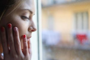 beginningstreatment-opium-addiction-photo-of-a-thoughtful-woman-near-the-window