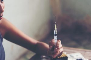 beginningstreatment-safe-injection-sites-pros-and-cons-photo-of-drug-addict-young-woman-syringe