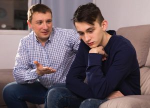 beginningstreatment-How-to-Admit-Addiction-to-Your-Kids-photo-of-a-boy-offended-father-asking-forgiveness