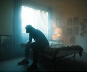 Depressed man sitting on his bed trying to detox