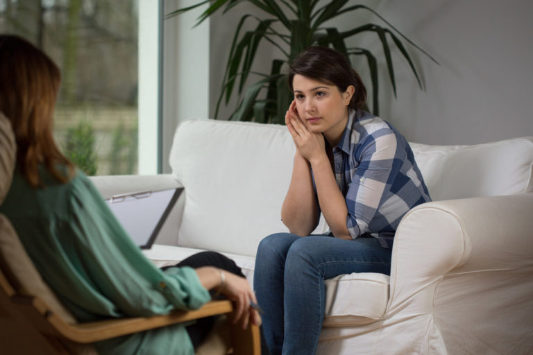 Woman in therapy talking with doctor in Orange County