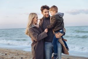 Happy family posing for a picture on the beach