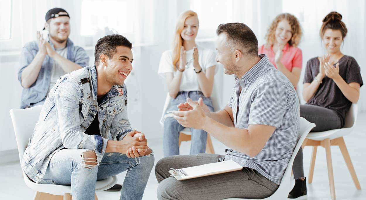 Group therapy talking with a therapist 