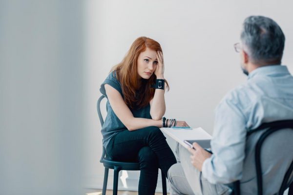 Woman talking to psychologist because of her drug addiction.