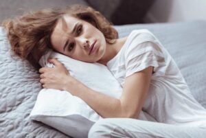 Sad woman holding a pillow experiencing Ativan Withdrawal