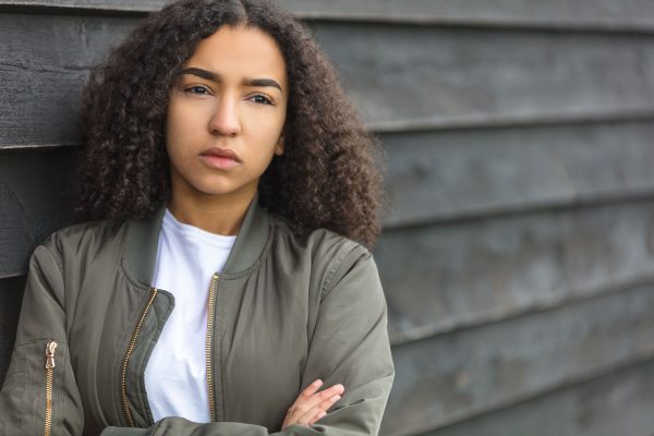 Woman leaning against wall