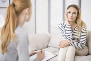 Woman talking to a psychologist helping her through addiction