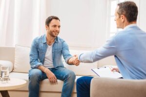 Male patent shaking hands with his therapist