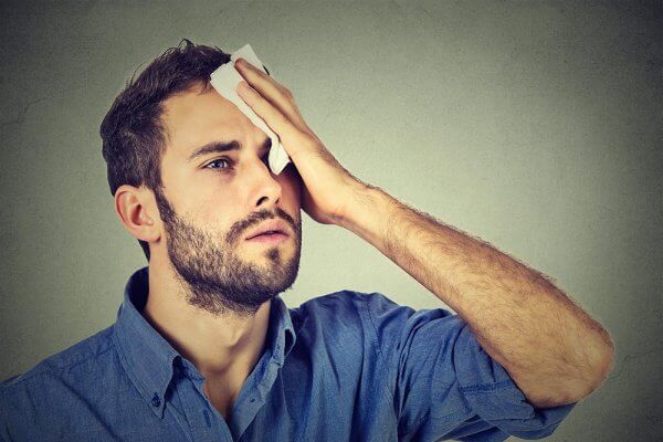 Man with headache during his detox