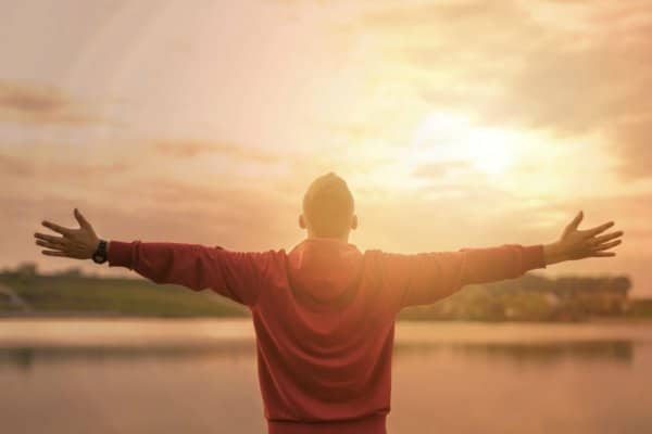 Man standing watching sunrise