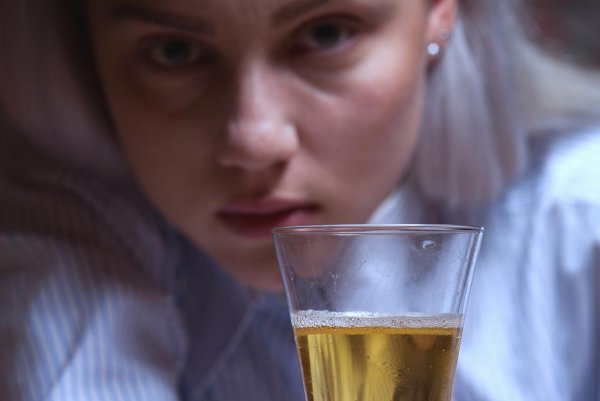 Woman tempted to drink beer in front of her