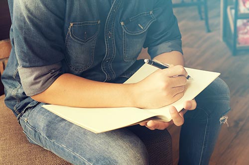 Man writing in journal