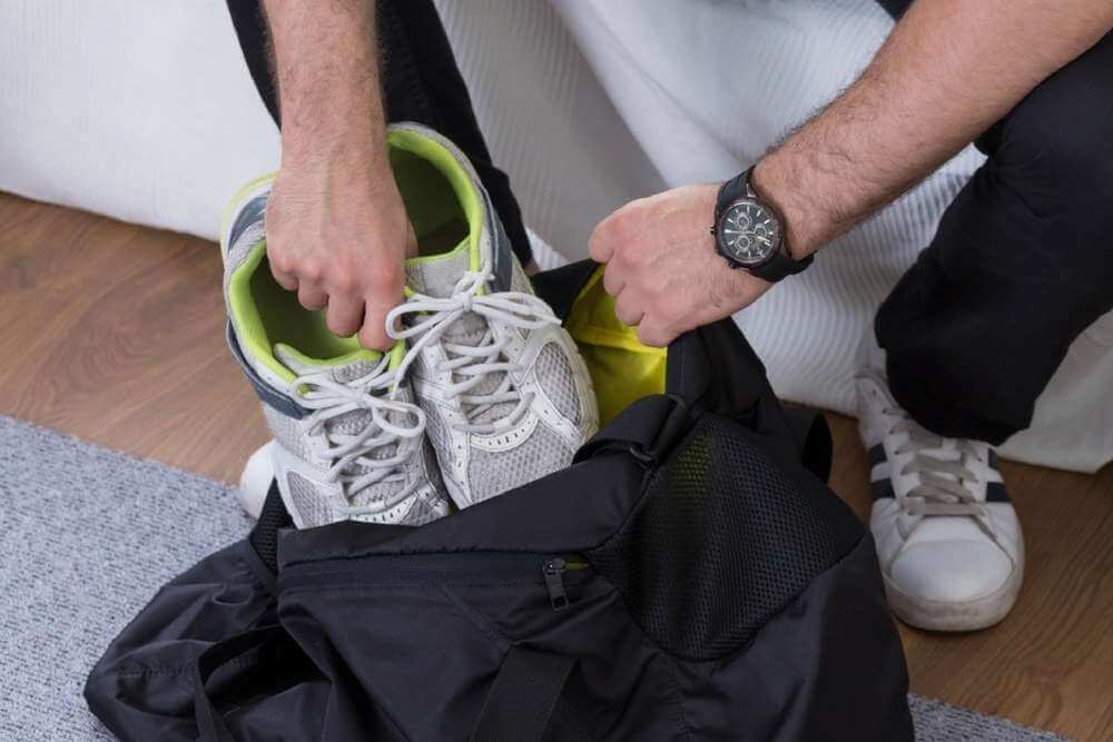 Man packing a bag for addiction treatment